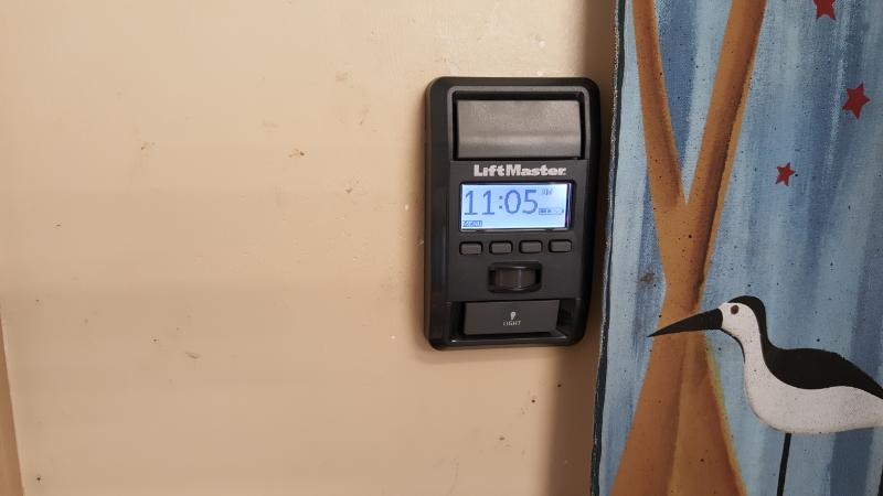 Wall button mounted on wall with display panel.