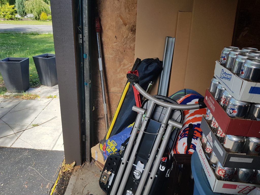 Garage door with no safety sensors and untidy area