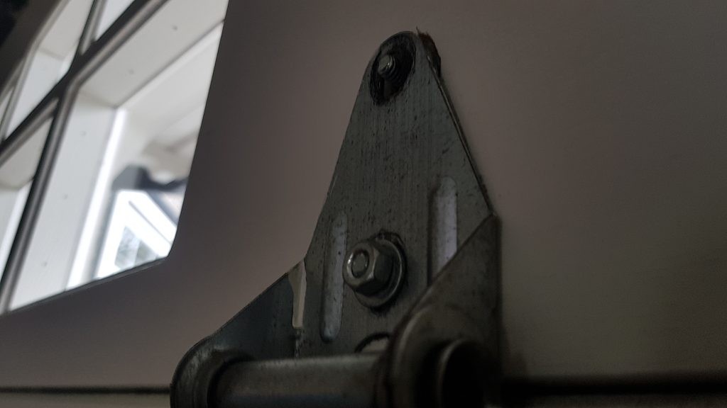 Hinge that needs to have a new nut fastened. This is a concern. Call us at: 604-940-8918 and we can arrange a service truck to repair andy garage door problems that you may have