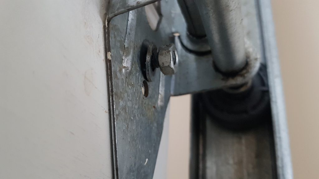 Nut on garage door hinge that is about to fall off in burnaby