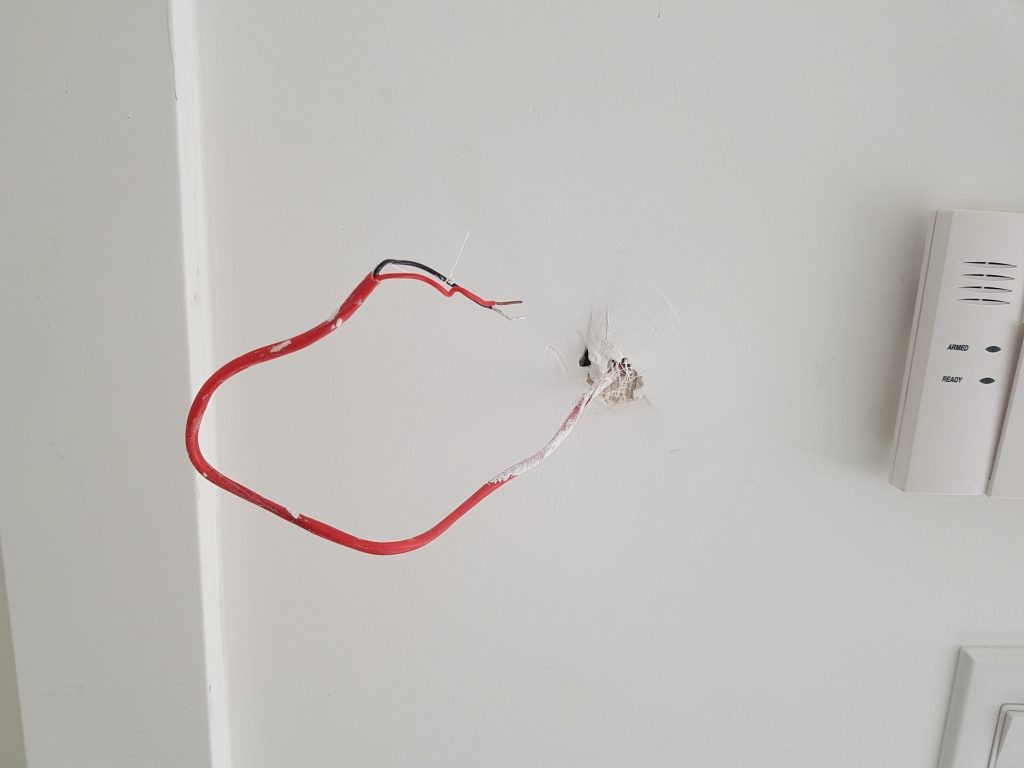 View of wall and control panel wires that need to be connected to the liftmaster wall button for garage door to operate.