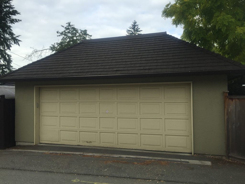 View of garage door that has short panels and no windows